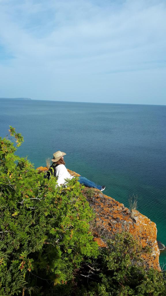A photo of A. C. Franklin, sitting at the edge of a cliff.